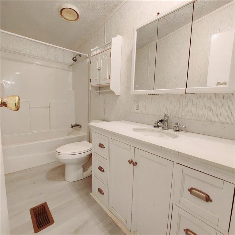 281 Mockingbird Drive Monticello, GA 31064 - Photo 21 of 42 a bathroom with a sink a toilet and shower