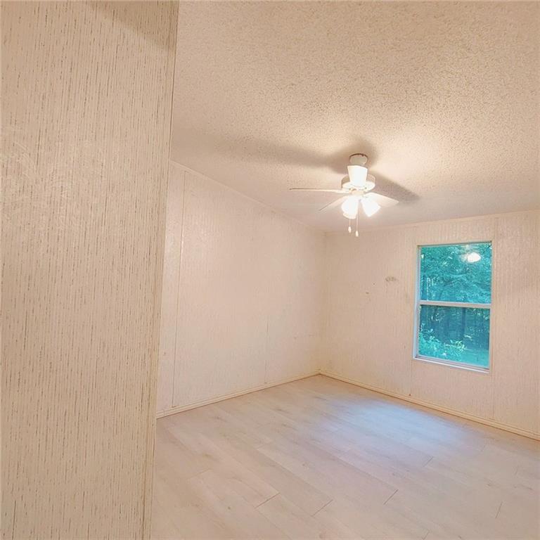 281 Mockingbird Drive Monticello, GA 31064 - Photo 24 of 42 an empty room with windows and fan