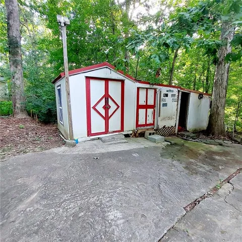 a view of house with outdoor space and car parked