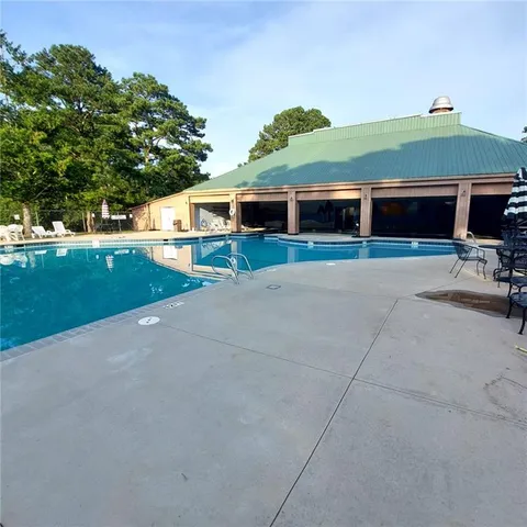 a view of a swimming pool with a yard