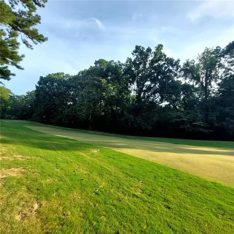a view of yard with swimming pool and green space
