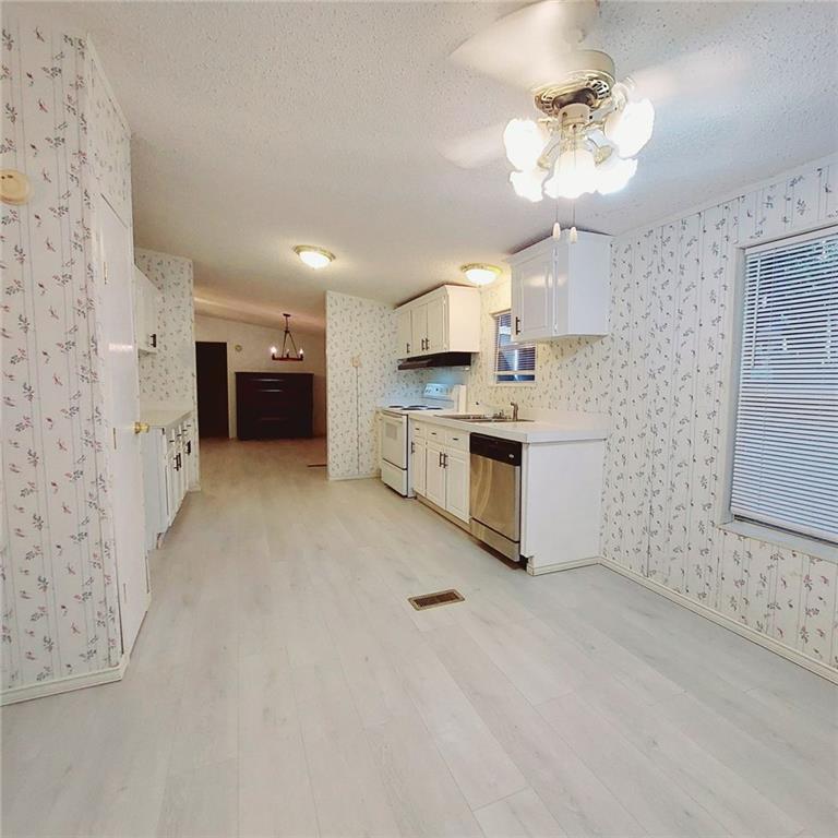 281 Mockingbird Drive Monticello, GA 31064 - Photo 6 of 42 a large kitchen with cabinets and stainless steel appliances