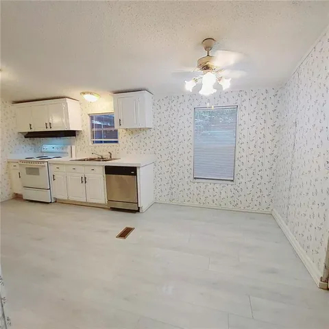 a view of a kitchen with a sink and a window