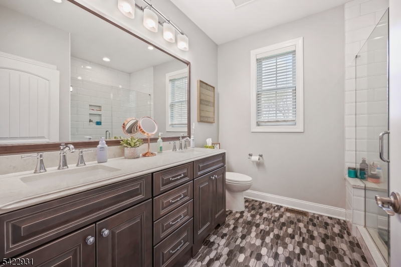 13 Fox Run Monroe Township, NJ 08831 - Photo 2 of 46 a spacious bathroom with a double vanity sink a mirror and a toilet