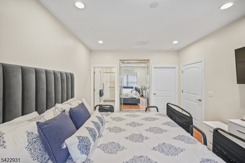 13 Fox Run Monroe Township, NJ 08831 - Photo 34 of 46 a large bedroom with a bed and wooden floor