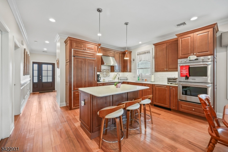 13 Fox Run Monroe Township, NJ 08831 - Photo 40 of 46 a kitchen with stainless steel appliances a dining table chairs stove refrigerator and cabinets