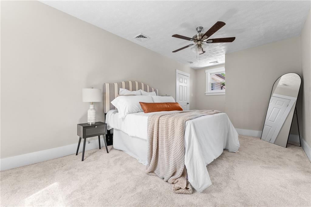 523 Cross Street Rochester, PA 15074 - Photo 23 of 41 a bedroom with a bed and a chair