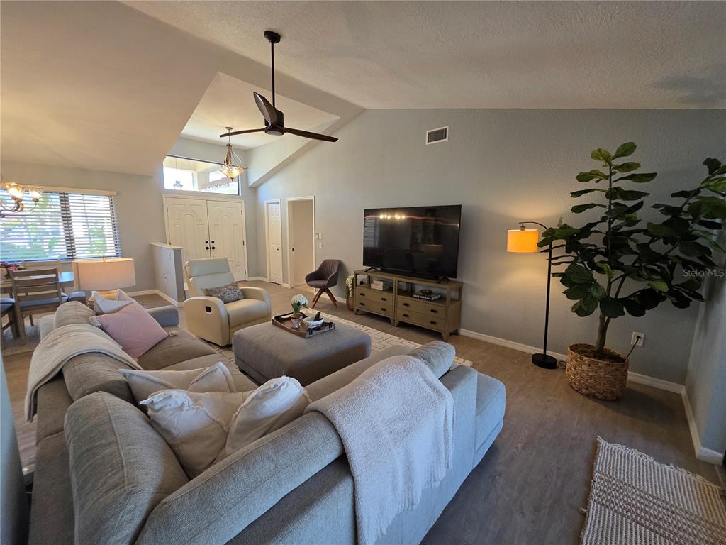 13 Seaward Circle Placida, FL 33946 - Photo 13 of 45 a living room with furniture a chandelier and a flat screen tv