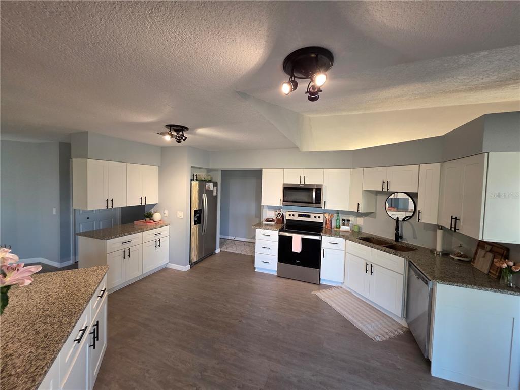 13 Seaward Circle Placida, FL 33946 - Photo 18 of 45 a large kitchen with cabinets wooden floor and stainless steel appliances