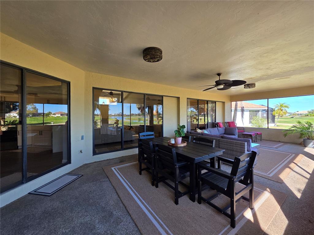 13 Seaward Circle Placida, FL 33946 - Photo 19 of 45 a view of a dining room and livingroom with furniture wooden floor and a rug