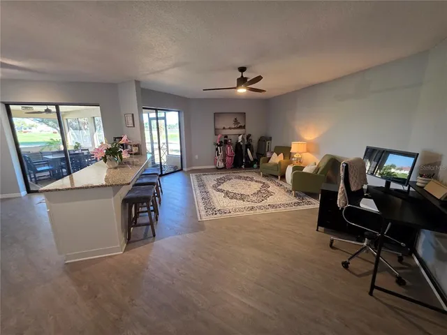 a living room with furniture a fireplace and a window
