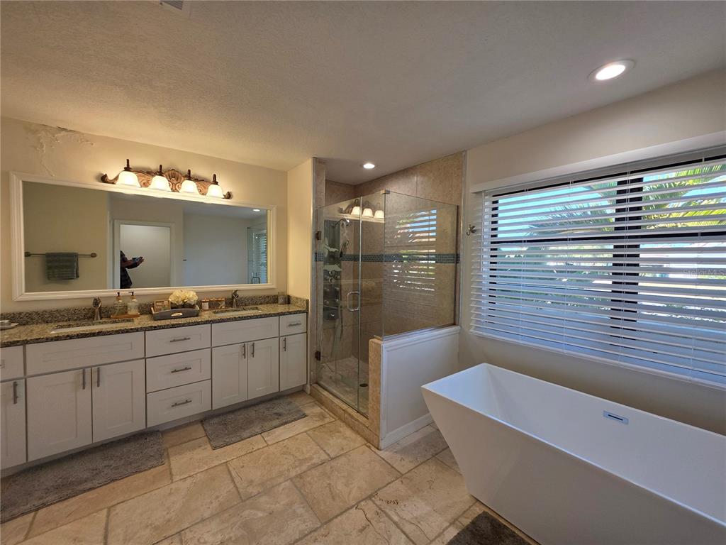 13 Seaward Circle Placida, FL 33946 - Photo 41 of 45 a bathroom with a tub sink and mirror