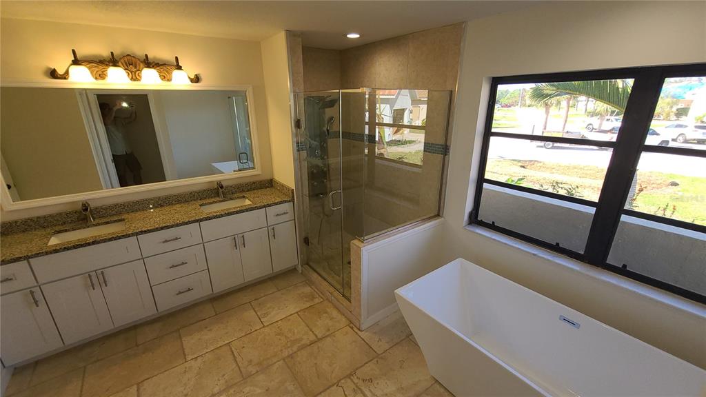 13 Seaward Circle Placida, FL 33946 - Photo 9 of 45 a bathroom with a sink a mirror and a bathtub