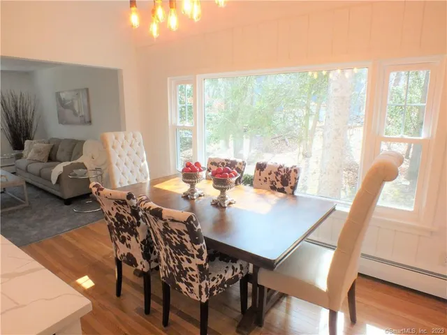 a view of a dining room with furniture window and wooden floor