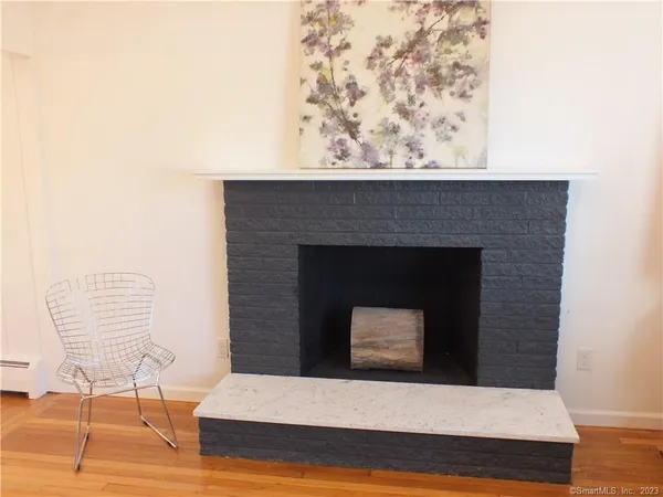 a room with a fireplace and wooden floor