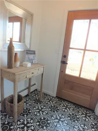 a bathroom with a window a sink and a mirror
