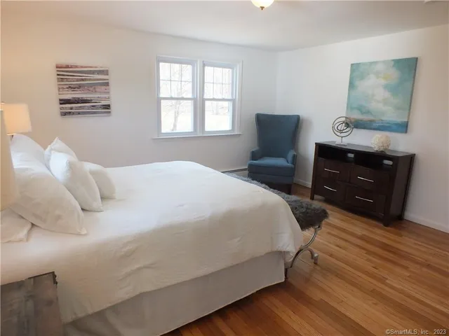 a bedroom with a bed and a television