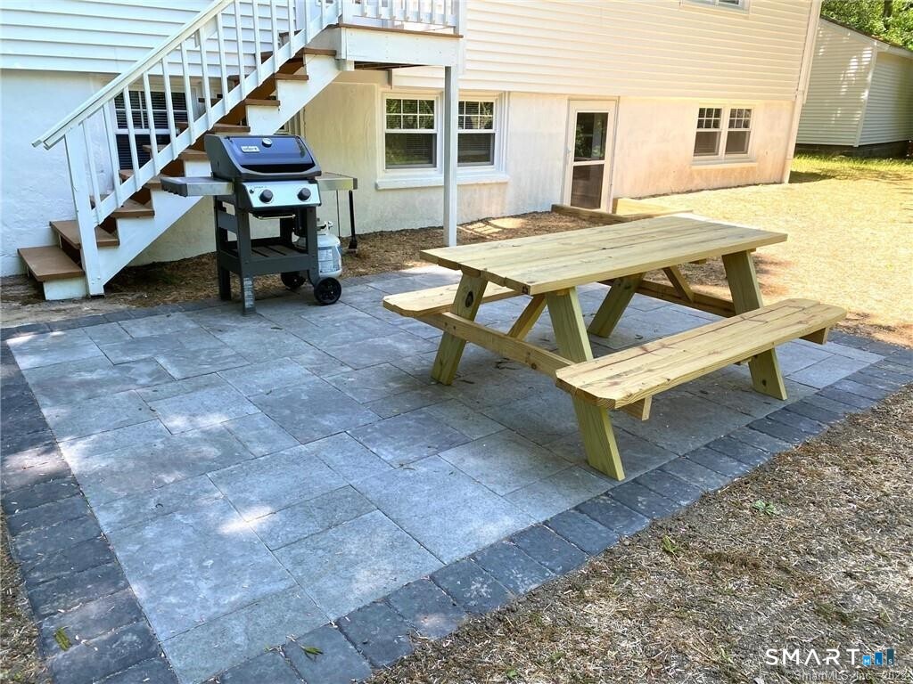 1025 Willard Road Orange, CT 06477 - Photo 32 of 40 a backyard of a house with table and chairs