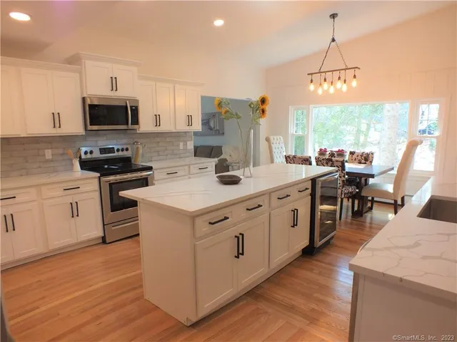 a kitchen with appliances a sink and cabinets