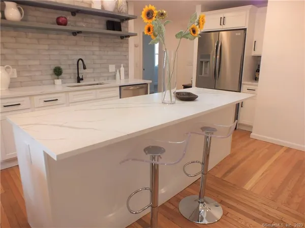 a kitchen with stainless steel appliances a sink and a refrigerator