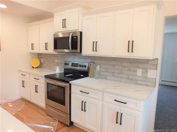 a kitchen with stainless steel appliances granite countertop a sink and a stove