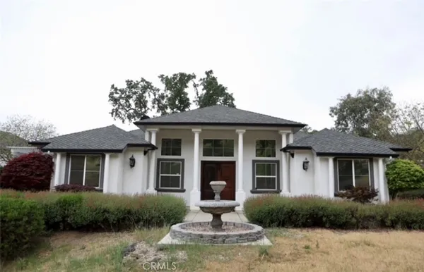 a front view of a house with garden