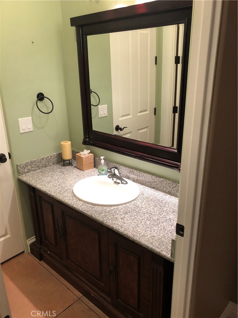 3200 San Fernando Road Atascadero, CA 93422 - Photo 24 of 45 a bathroom with a granite countertop sink and a mirror