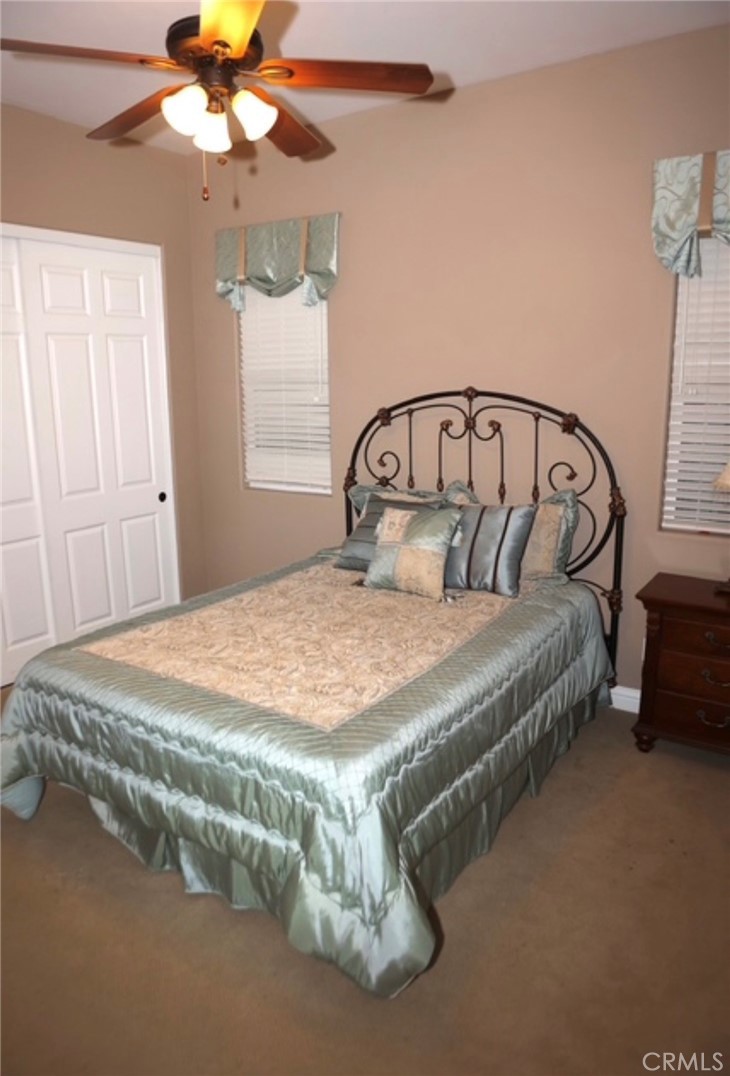 3200 San Fernando Road Atascadero, CA 93422 - Photo 25 of 45 a bedroom with a bed and a chandelier