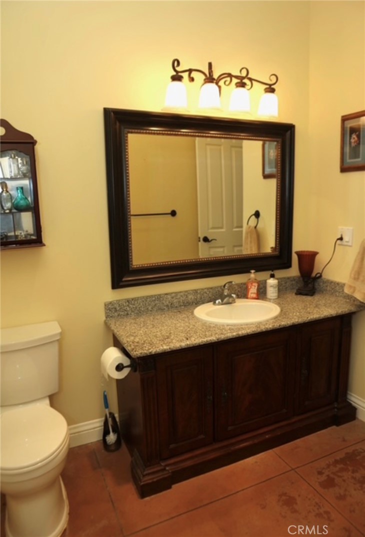 3200 San Fernando Road Atascadero, CA 93422 - Photo 9 of 45 a bathroom with a granite countertop sink and a toilet