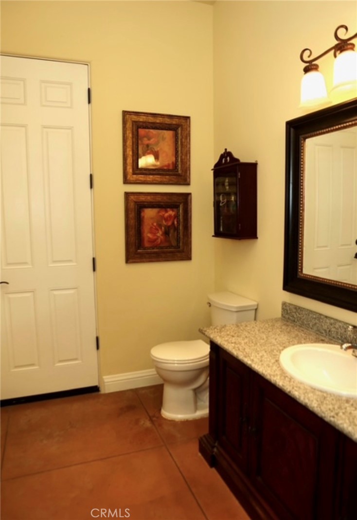 3200 San Fernando Road Atascadero, CA 93422 - Photo 10 of 45 a bathroom with a granite countertop sink toilet and mirror