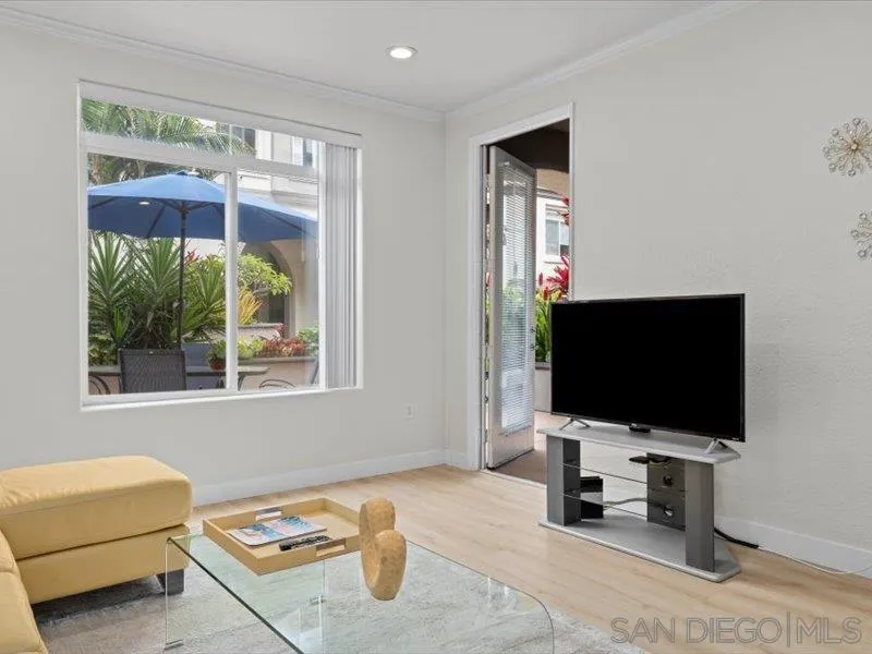 9237 Regents Road, Unit K101 La Jolla, CA 92037 - Photo 6 of 29 a living room with furniture and a flat screen tv