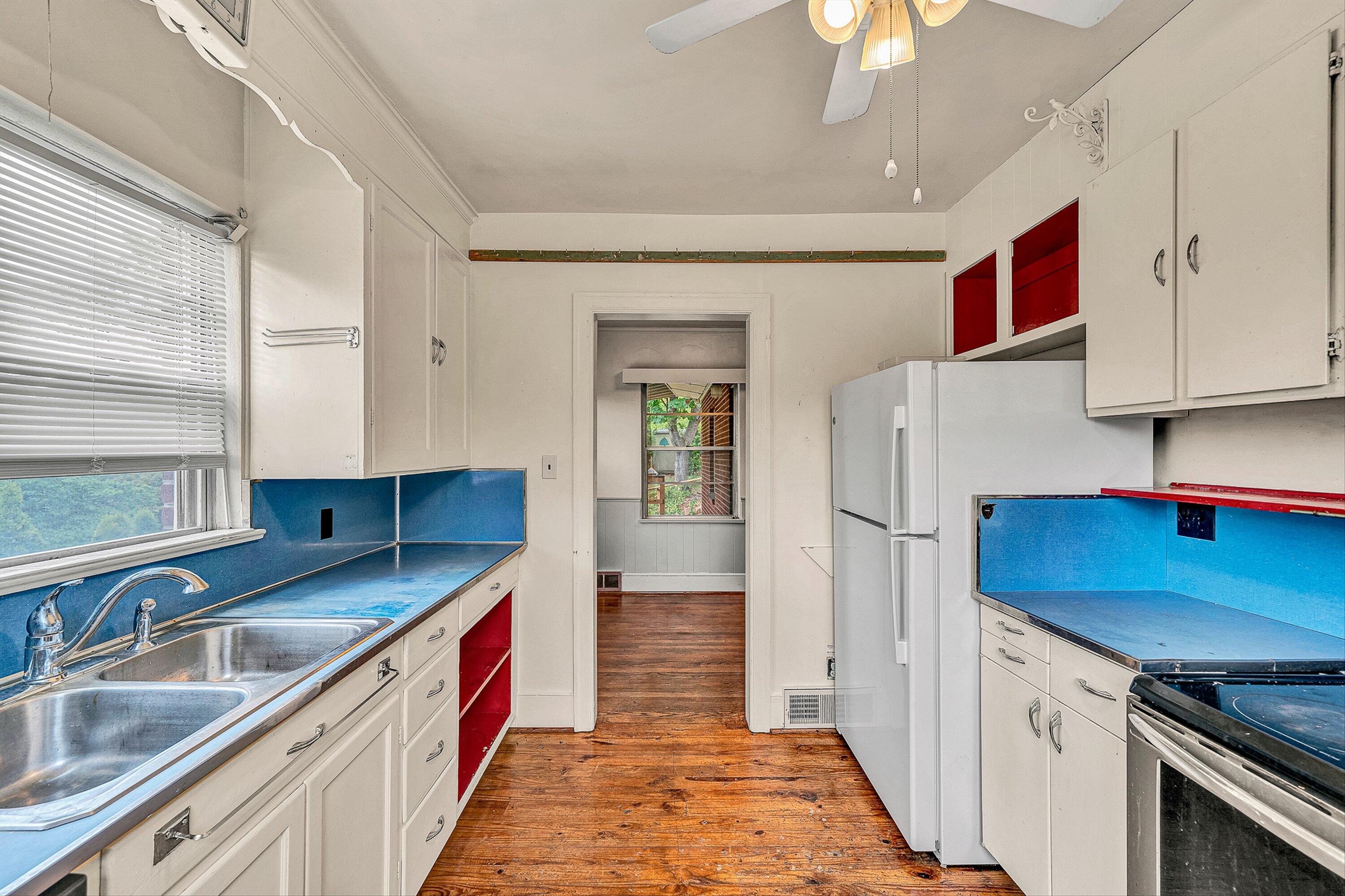 1917 Langdon Road Southwest Roanoke, VA 24015 - Photo 11 of 42 a kitchen with stainless steel appliances granite countertop a sink and a refrigerator