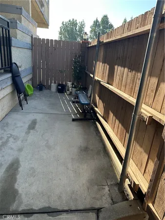 a view of deck with chairs and wooden fence