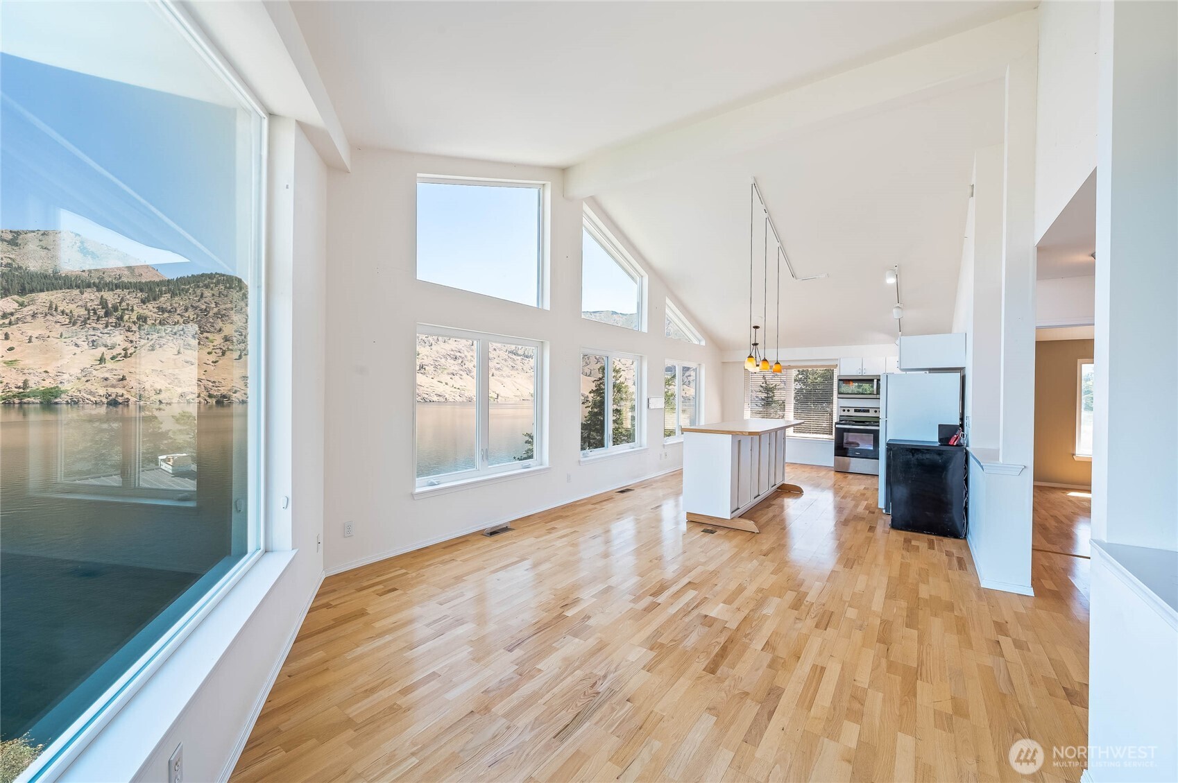 20000 South Lakeshore Road Chelan, WA 98816 - Photo 28 of 37 a view of a living room and kitchen with a large window