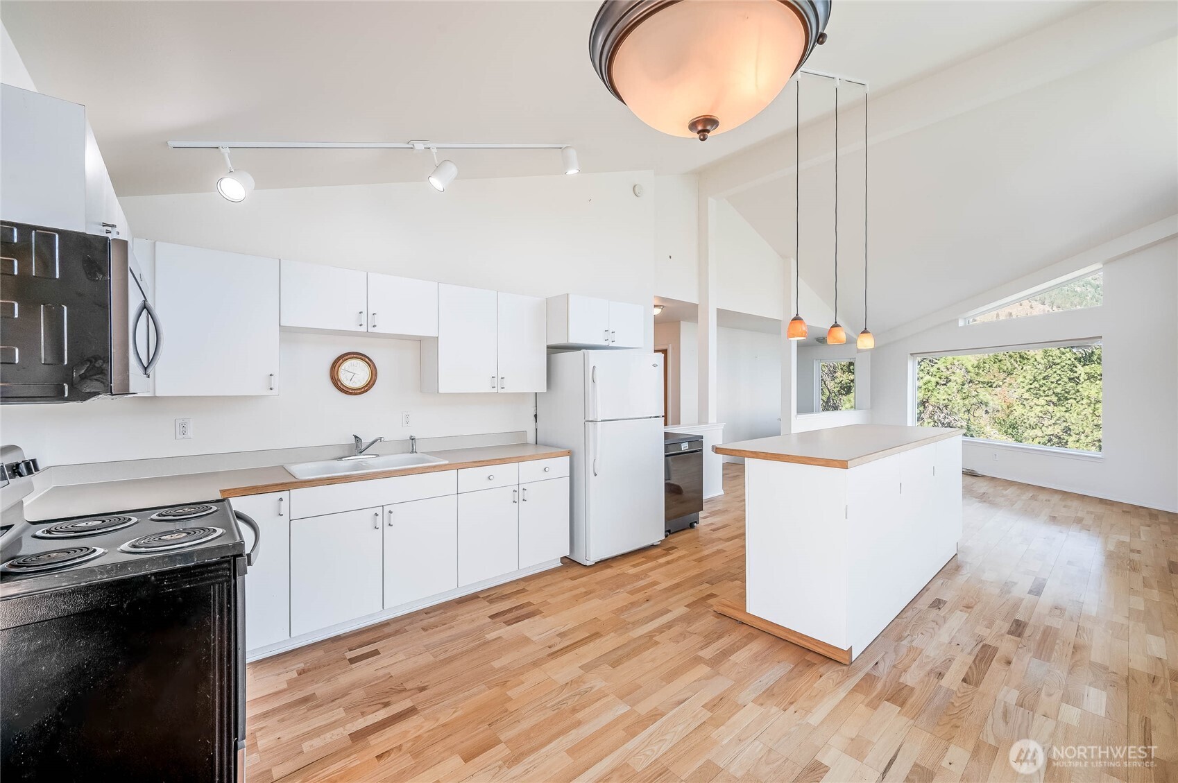 20000 South Lakeshore Road Chelan, WA 98816 - Photo 30 of 37 a kitchen with stainless steel appliances granite countertop a sink a stove a refrigerator and island with wooden floor