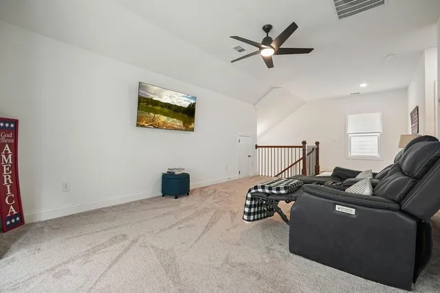 an aerial view of a house with a yard and lake view