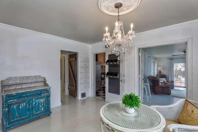 3917 Haddon Road Denver, CO 80205 - Photo 11 of 40 a living room with furniture a chandelier and a mirror