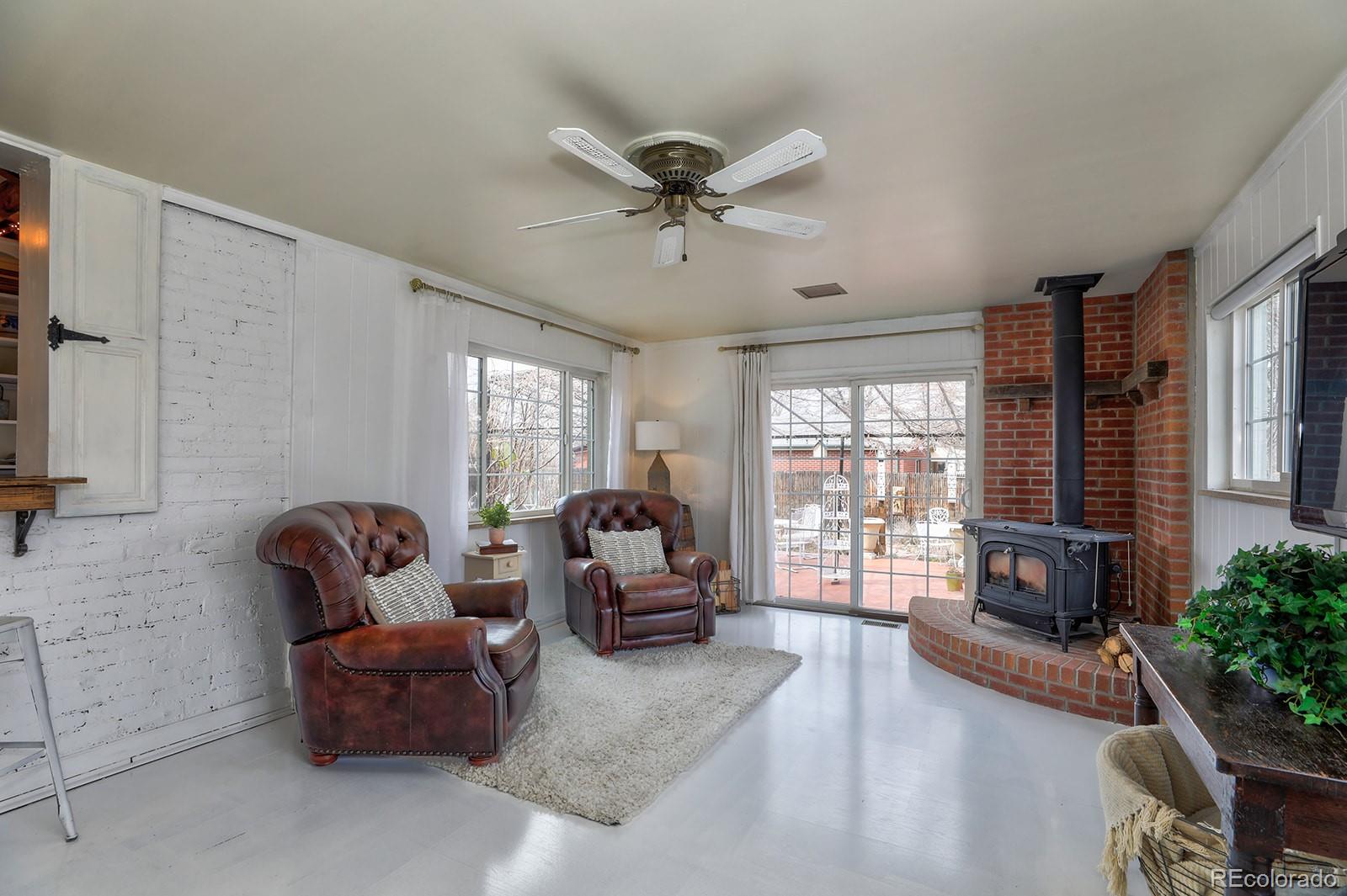 3917 Haddon Road Denver, CO 80205 - Photo 12 of 40 a living room with furniture ceiling fan and a window