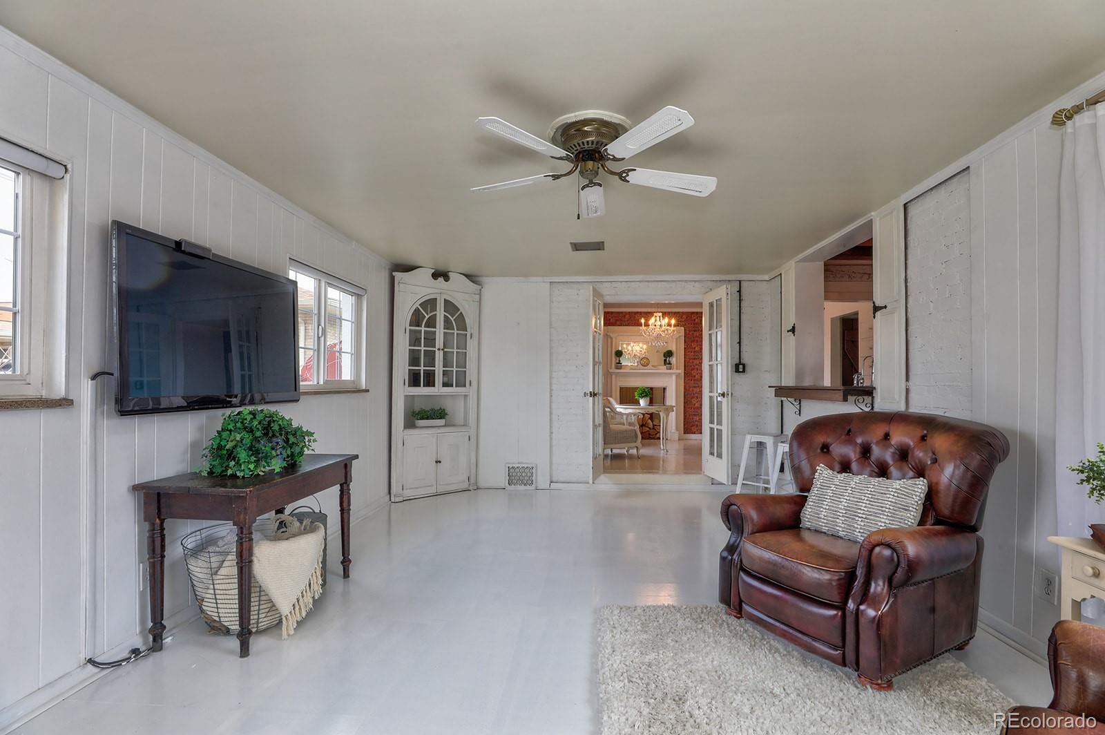 3917 Haddon Road Denver, CO 80205 - Photo 13 of 40 a living room with furniture and a chandelier