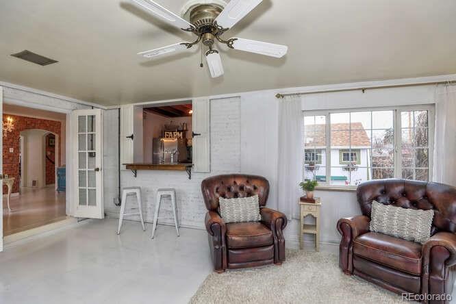 3917 Haddon Road Denver, CO 80205 - Photo 14 of 40 a living room with furniture ceiling fan and a window