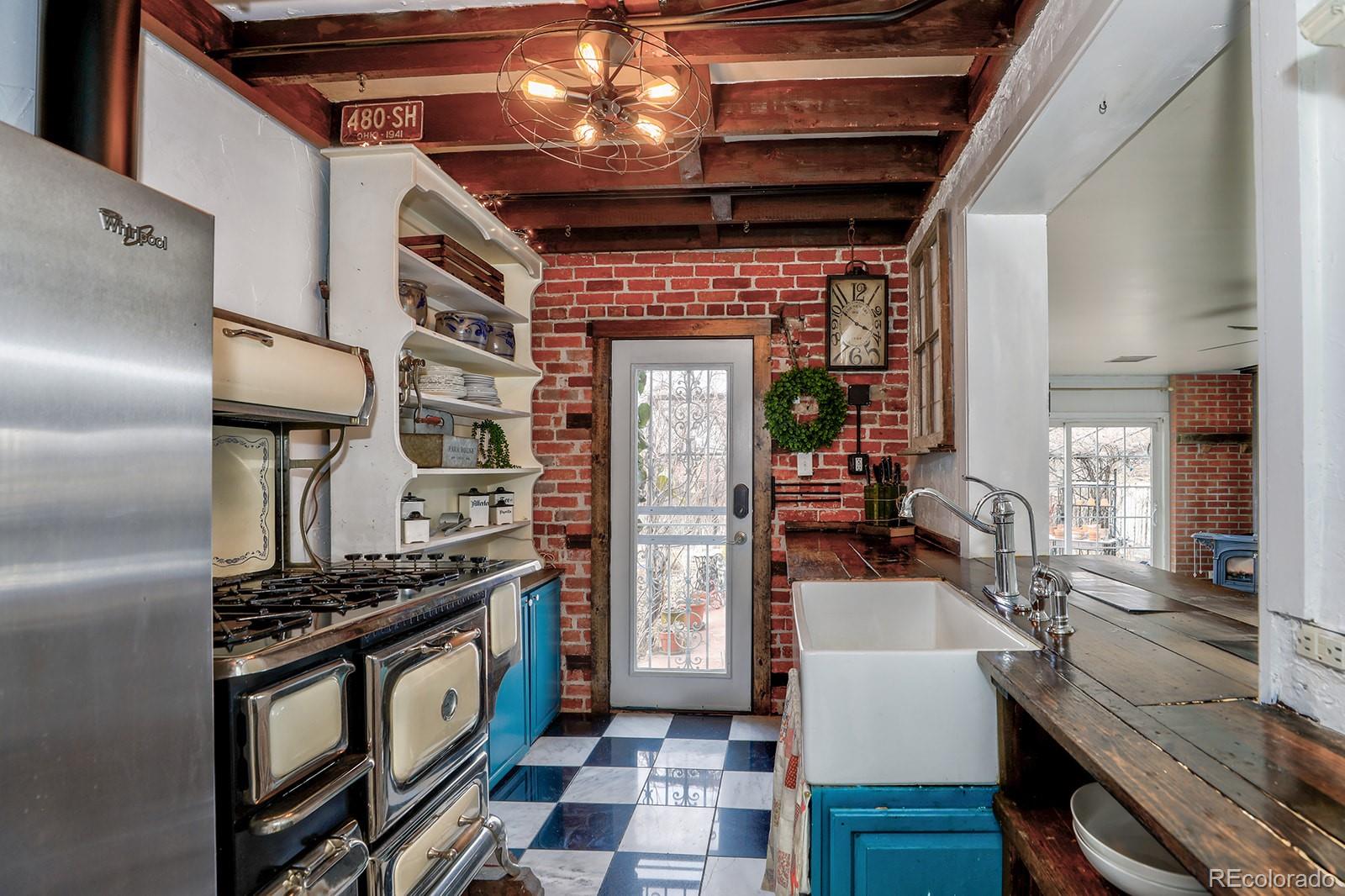3917 Haddon Road Denver, CO 80205 - Photo 17 of 40 a kitchen with stainless steel appliances granite countertop a stove and a refrigerator