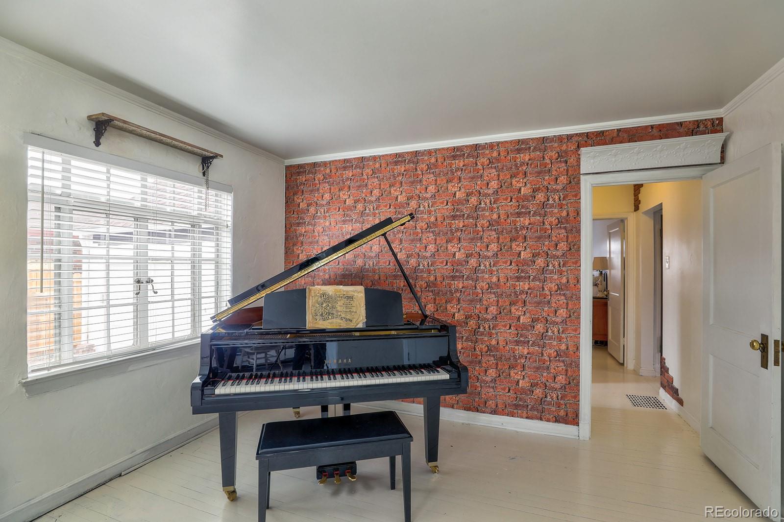 3917 Haddon Road Denver, CO 80205 - Photo 19 of 40 a house that has a bench and a window
