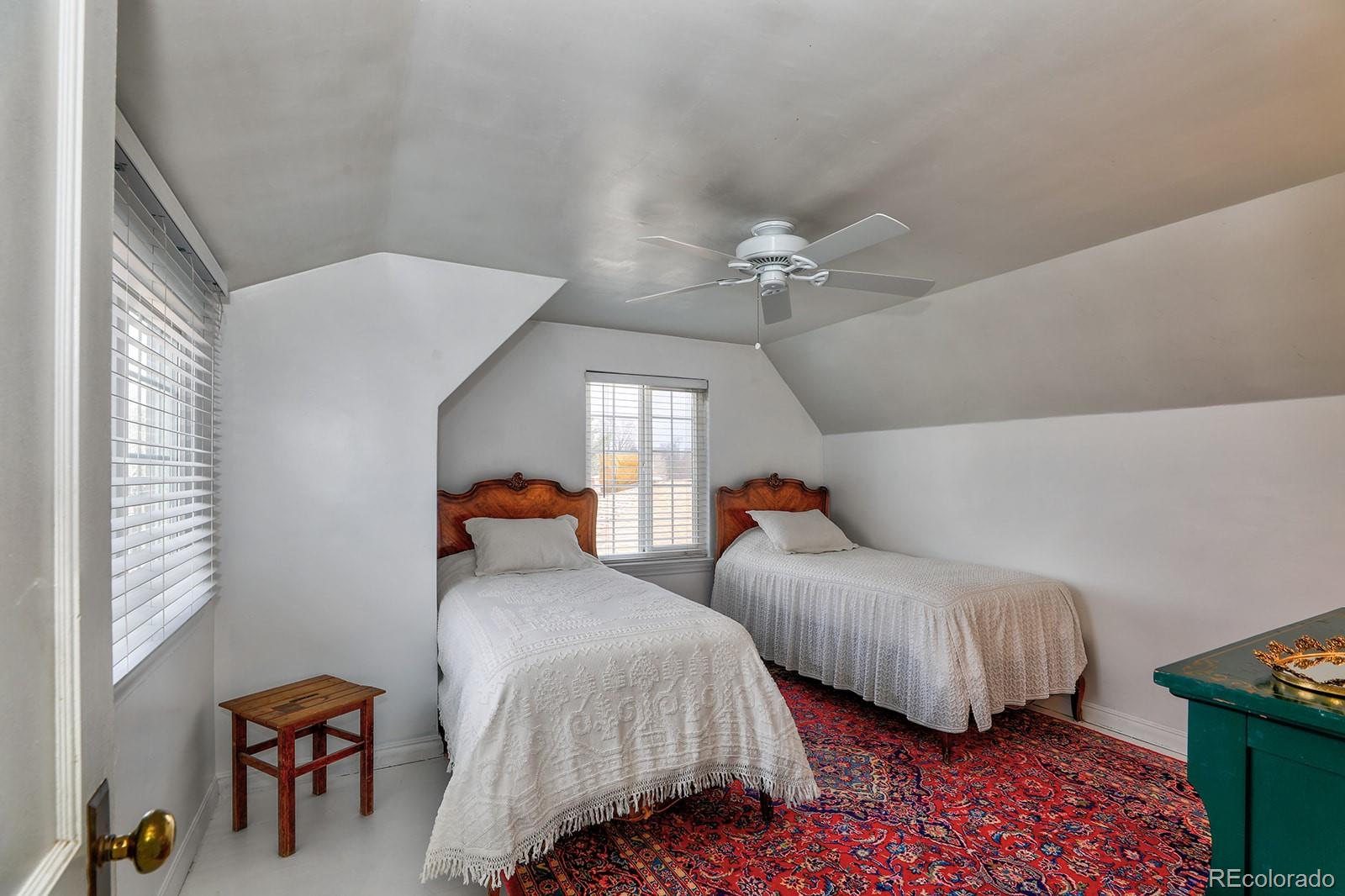 3917 Haddon Road Denver, CO 80205 - Photo 26 of 40 a bedroom with two beds and painting on the wall
