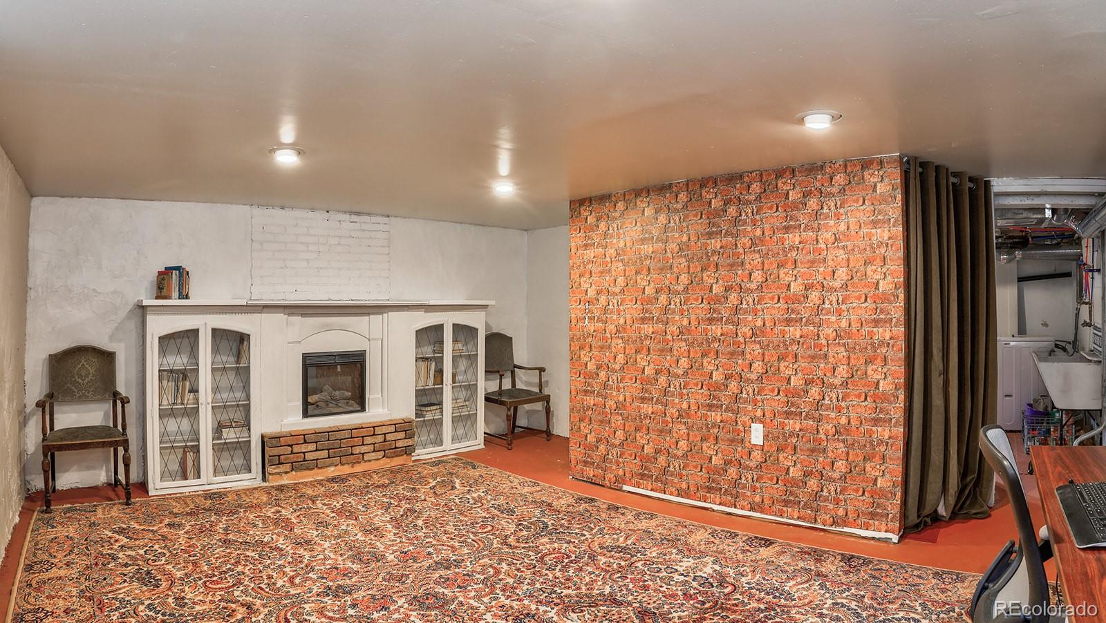 3917 Haddon Road Denver, CO 80205 - Photo 28 of 40 a big room with wooden floor and windows