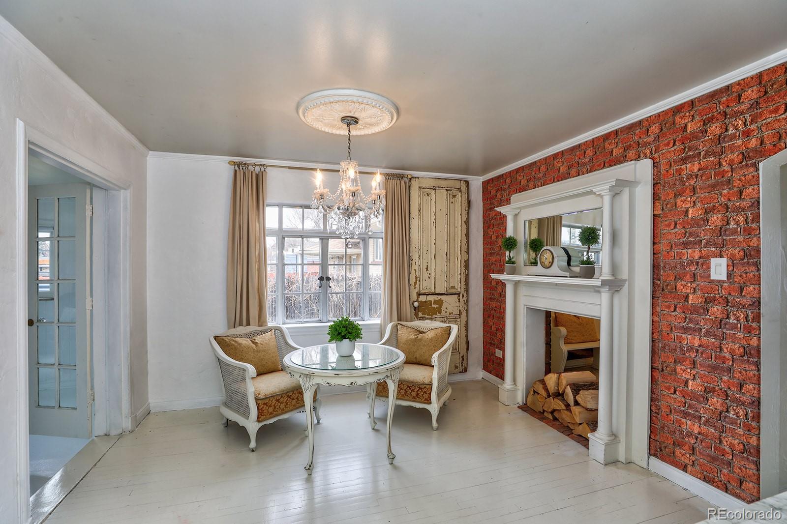 3917 Haddon Road Denver, CO 80205 - Photo 9 of 40 a view of a livingroom with furniture and a fireplace