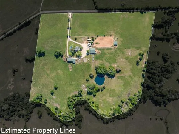 an aerial view of a residential houses with outdoor space