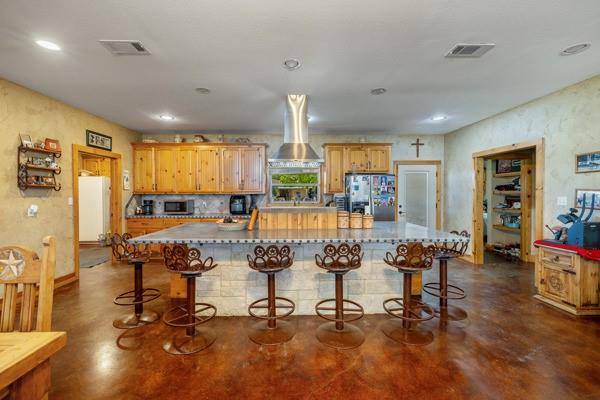 6808 Cedar Hill Road Brenham, TX 77833 - Photo 6 of 40 a view of a kitchen with dining table and chairs
