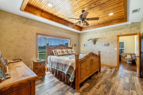 6808 Cedar Hill Road Brenham, TX 77833 - Photo 8 of 40 a bedroom with a bed and wooden floor
