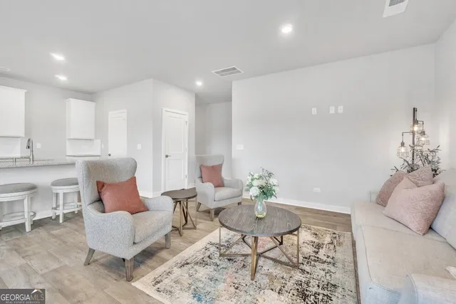 a living room with furniture and a potted plant