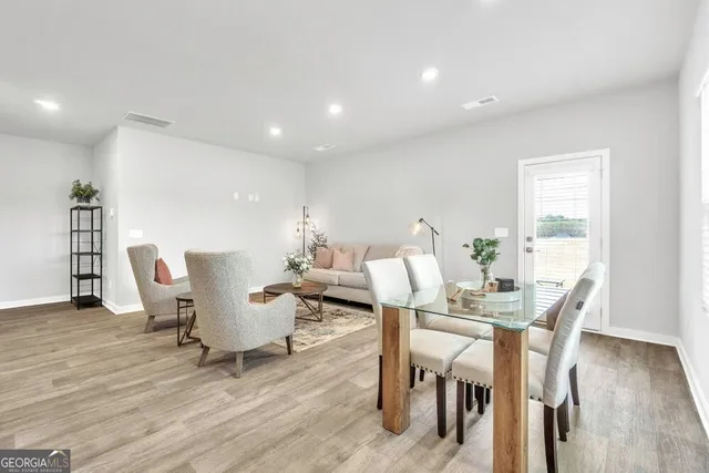 a view of a dining room with furniture and wooden floor